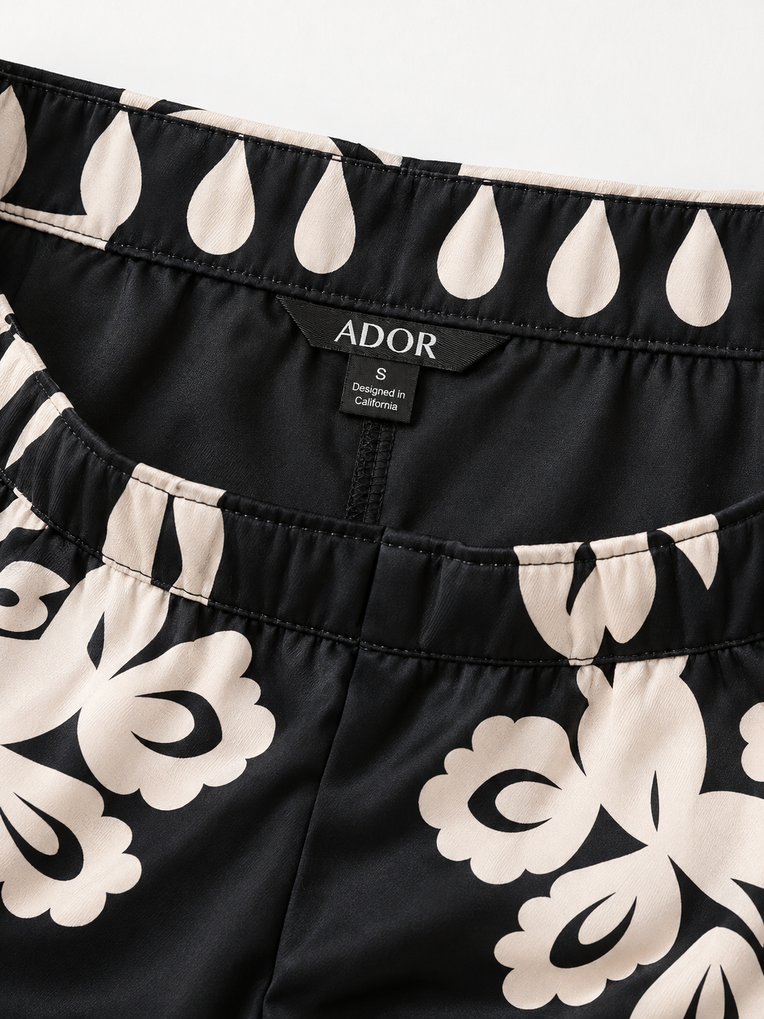 ADOR brand label detail on Black Ethnic Print Straight Leg Satin Pants