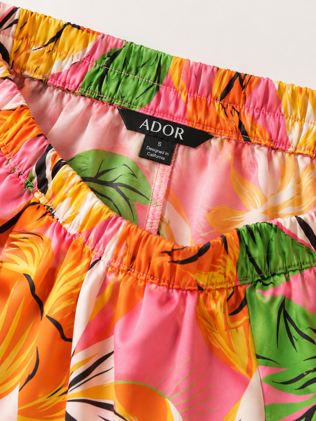 ADOR brand label detail on Wild Hibiscus Dream Silky Satin Wide Leg Pants