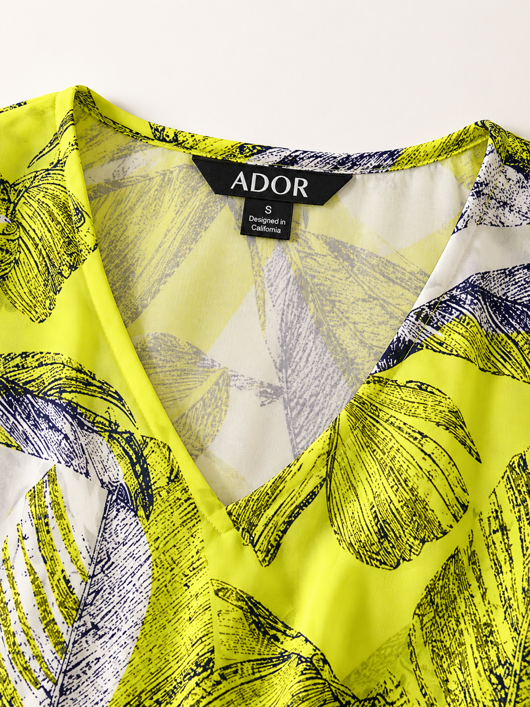 ADOR brand label detail on Citrus Palm Luxe Flowy Chiffon Blouse