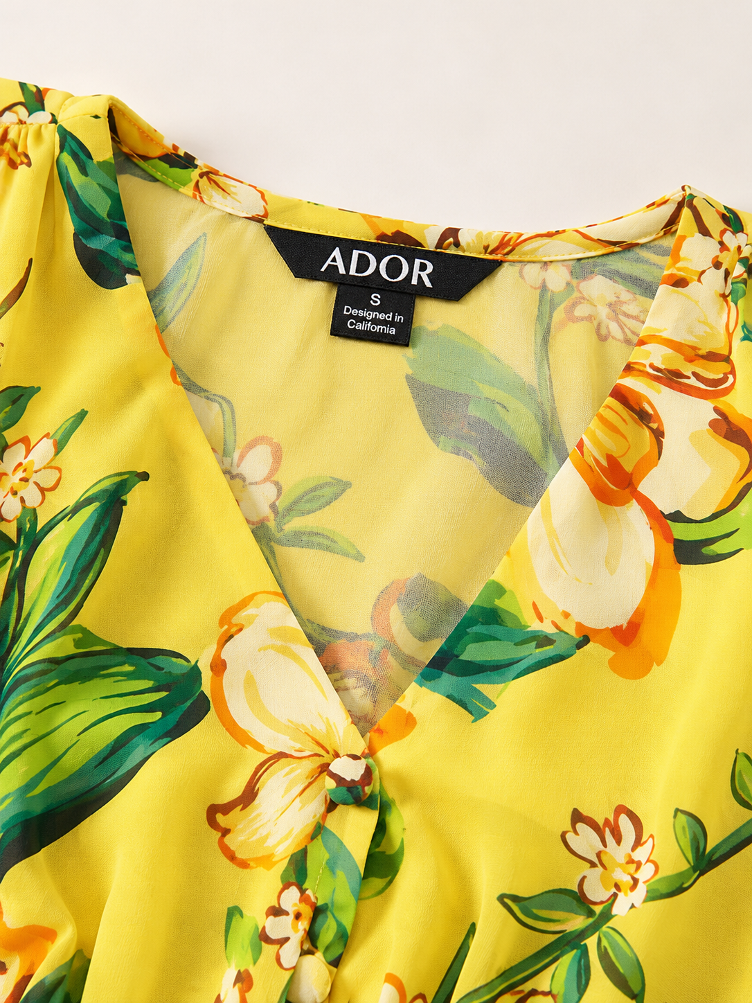 ADOR brand label detail on Lime Magnolia Glow Flowy Chiffon Maxi Dress