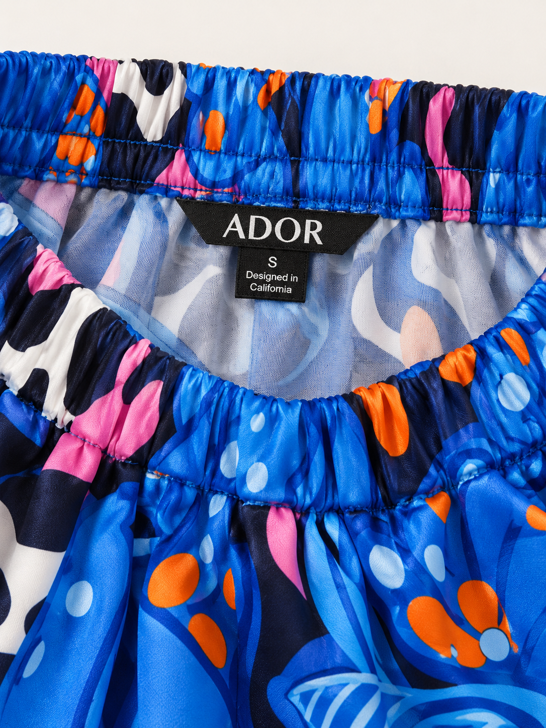 ADOR brand label detail on Abstract Azure Silky Satin Wide Leg Pants
