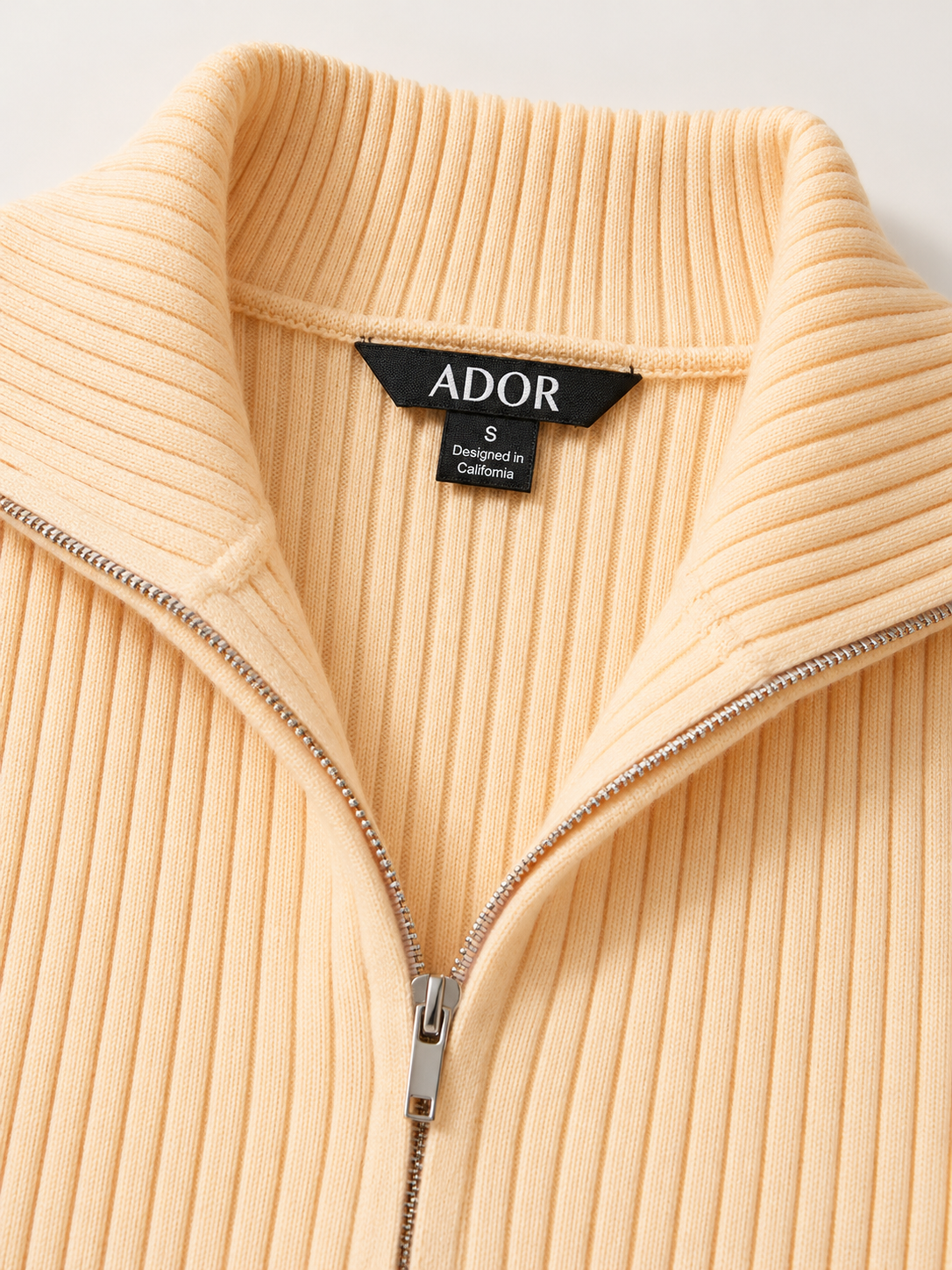 ADOR brand label detail on Yellow Modal Core Spun Yarn Zip Up Knit Cardigan