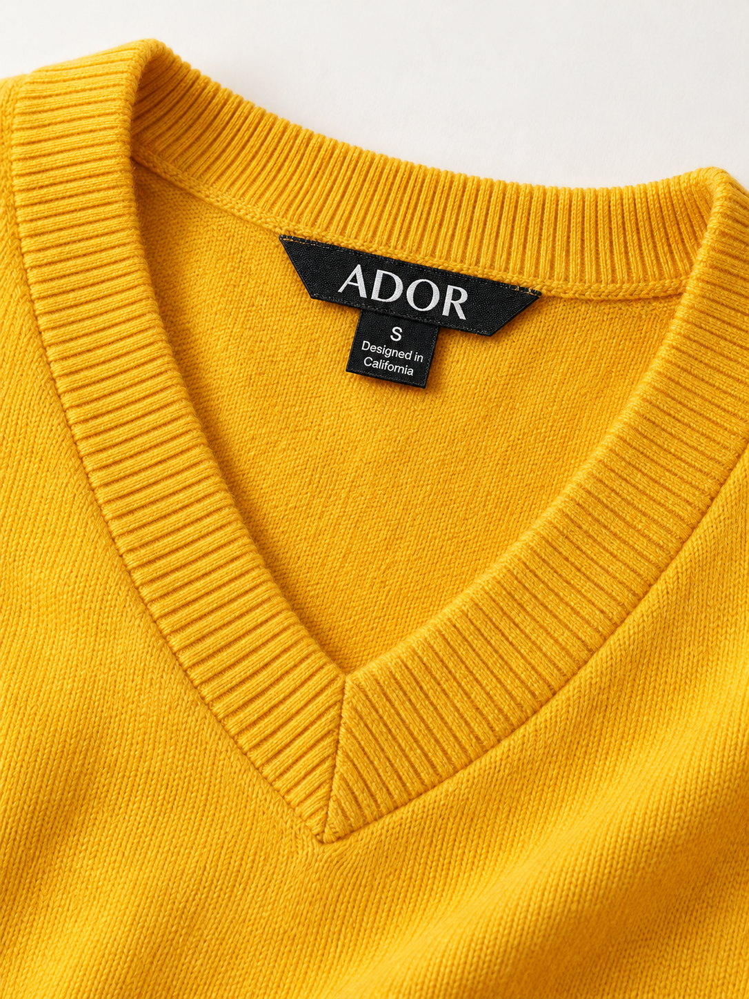 ADOR brand label detail on Wool Blend V-Neck Pullover Sweater