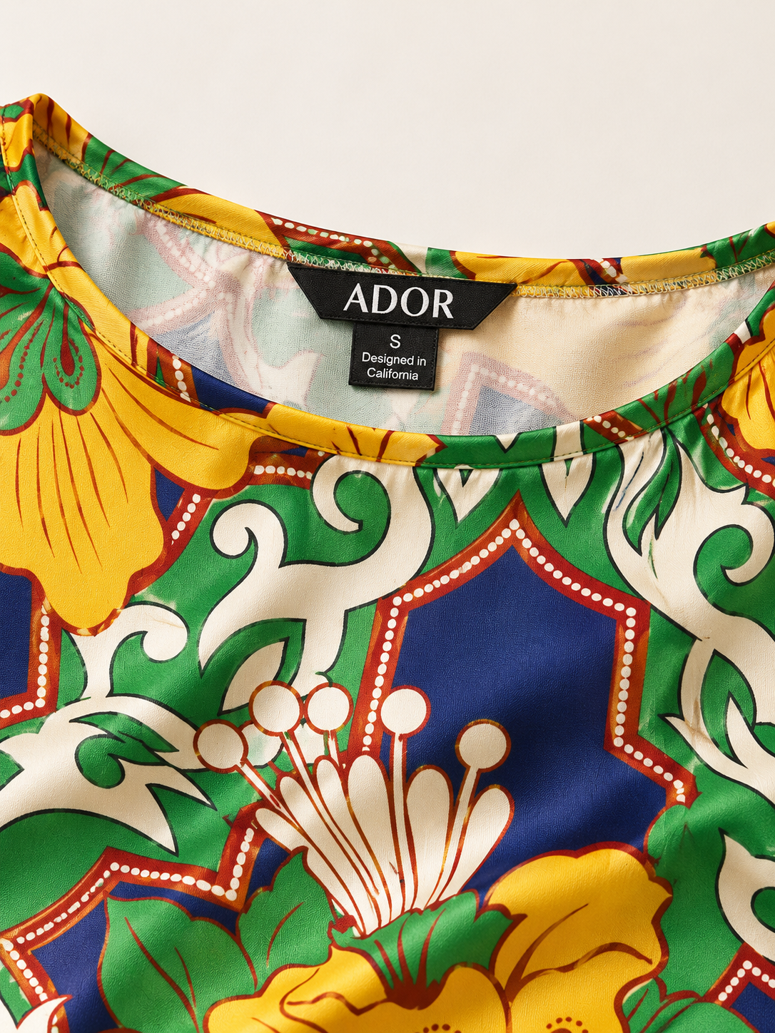 ADOR brand label detail on Emerald Bloom Bazaar Silky Satin Batwing Top