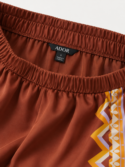 ADOR brand label detail on Brown Bohemia Silky Satin Wide Leg Pants
