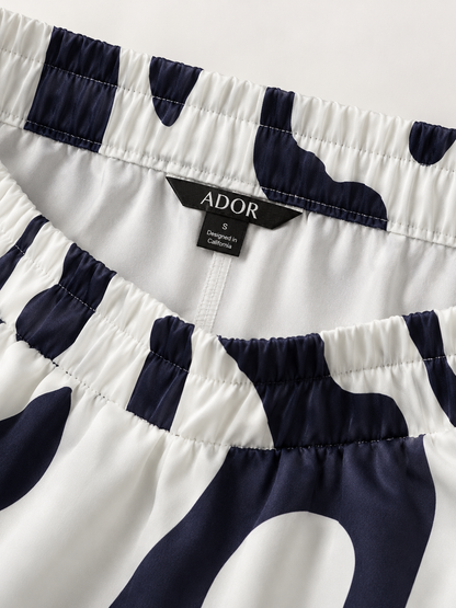 ADOR brand label detail on Artistic Graphic Silky Satin Wide Leg Pants