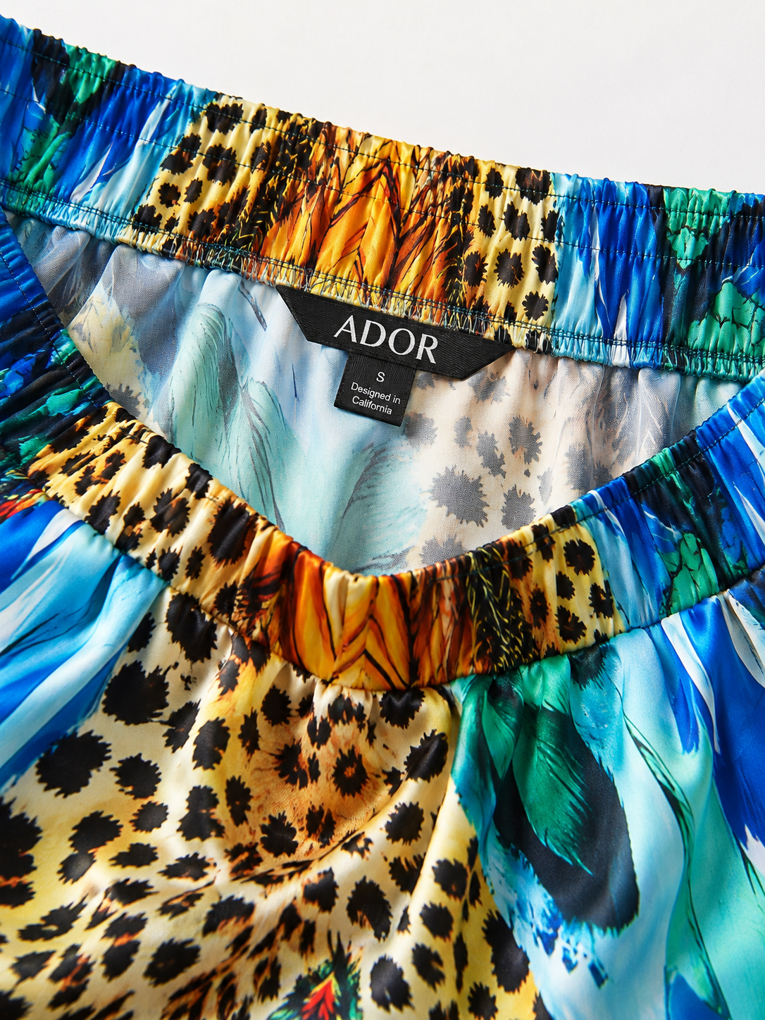 ADOR brand label detail on Jungle Wild Party Silky Satin Leopard Pants