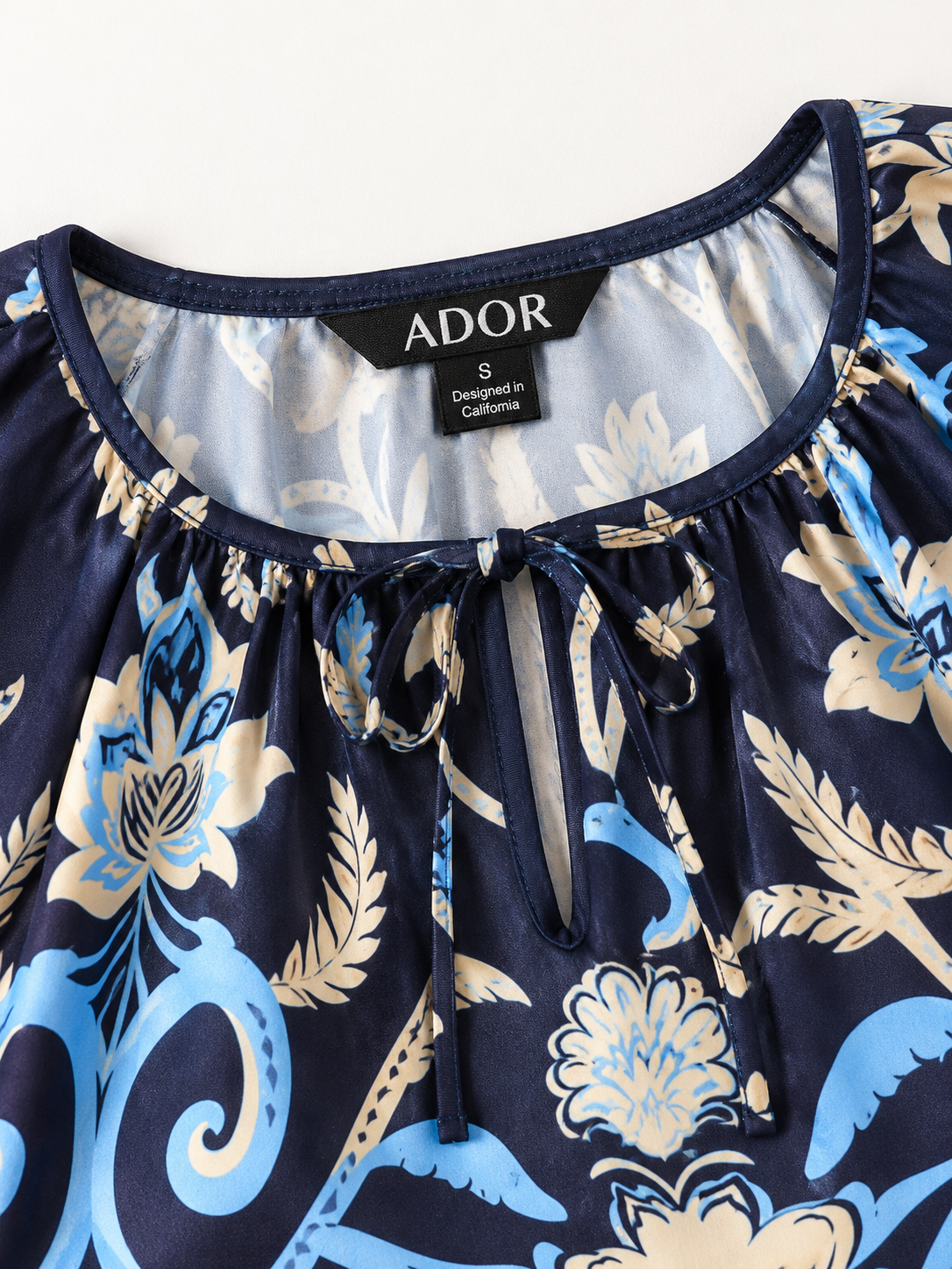 ADOR brand label detail on Summer Night Palm Silky Satin Maxi Dress