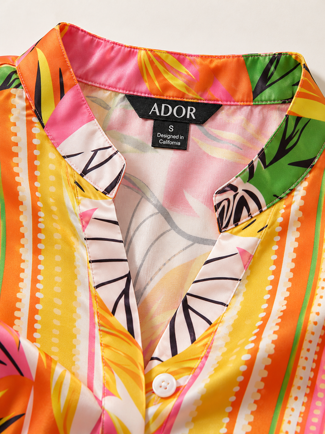 ADOR brand label detail on Wild Hibiscus Dream Silky Satin Ruched Maxi Dress