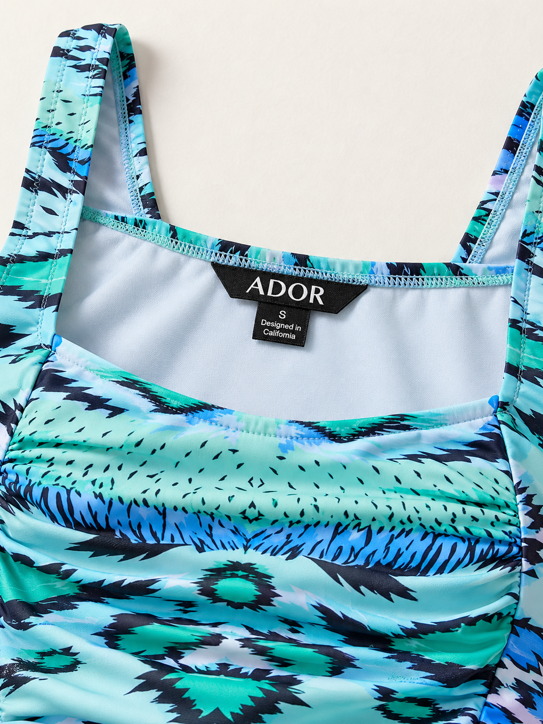 ADOR brand label detail on Land of Wonder Vacation One Piece Swimsuit