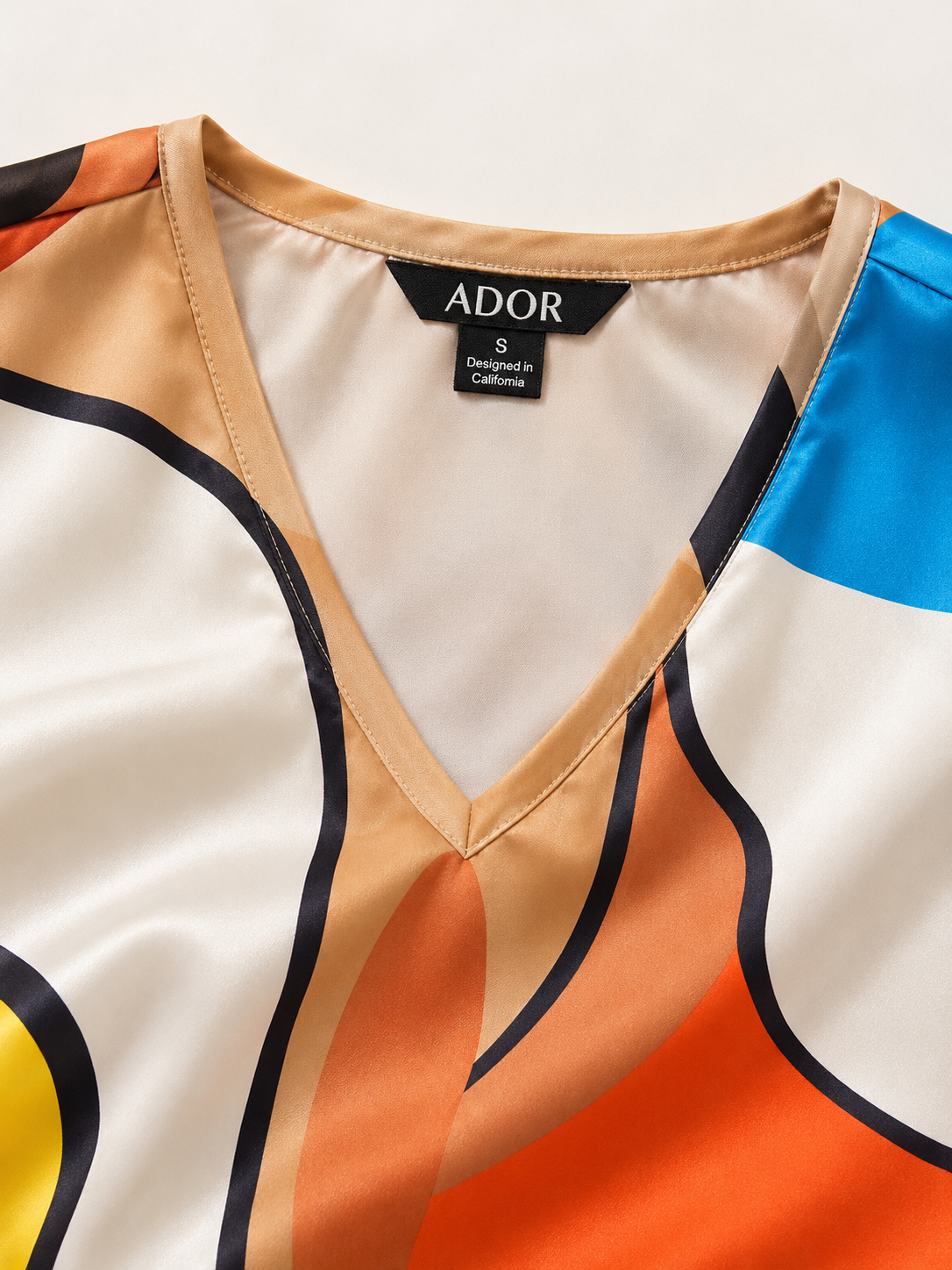 ADOR brand label detail on Abstract Art Silky Satin V Neck Batwing Top