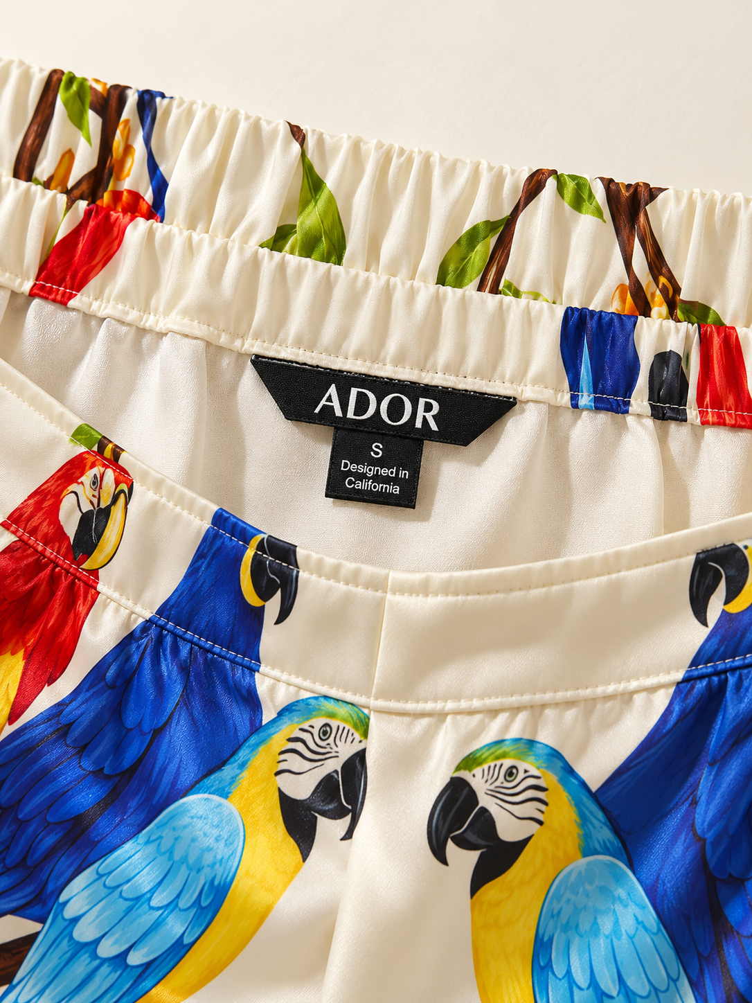 ADOR brand label detail on Canopy Song Silky Satin Elastic Waist Wide Leg Pants