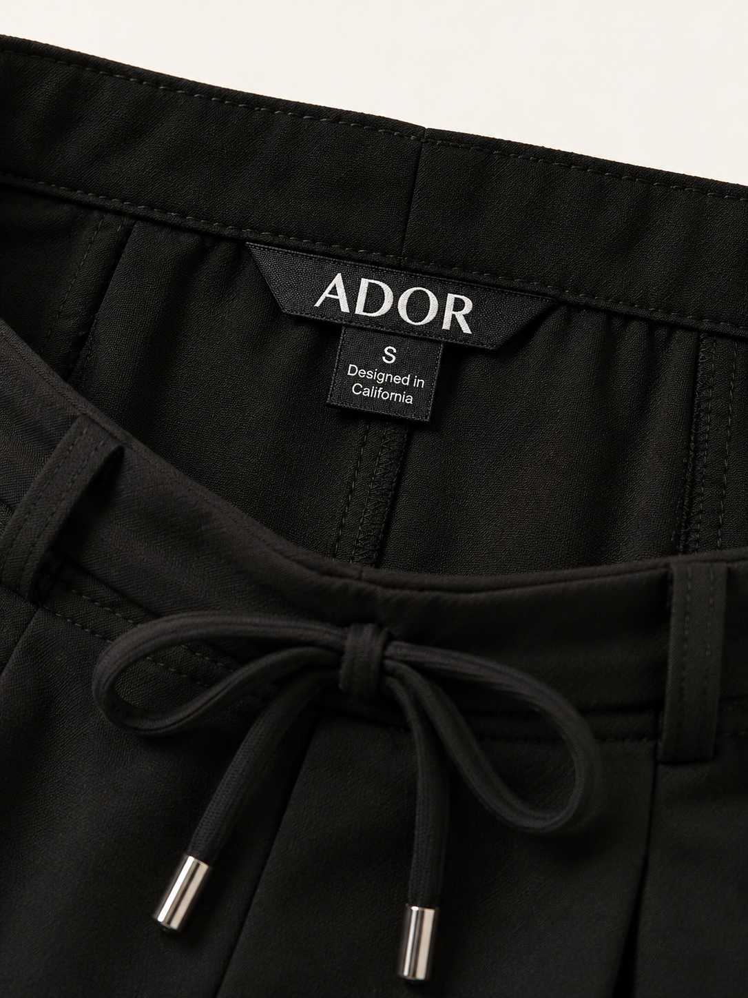 ADOR brand label detail on Essential Series Cotton-Like Pant