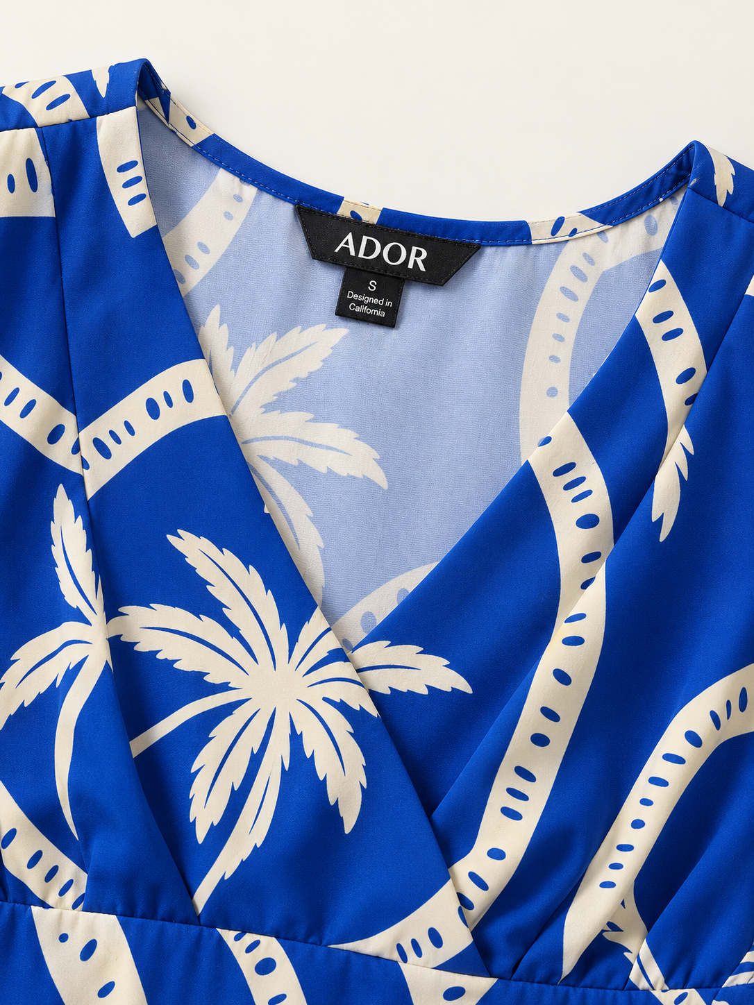 ADOR brand label detail on Geometric Print High Slit Beach Long Top
