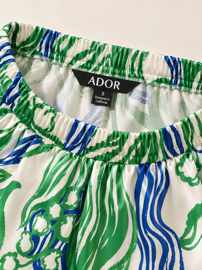 ADOR brand label detail on Abstract Bell Flower Satin Wide Leg Pants