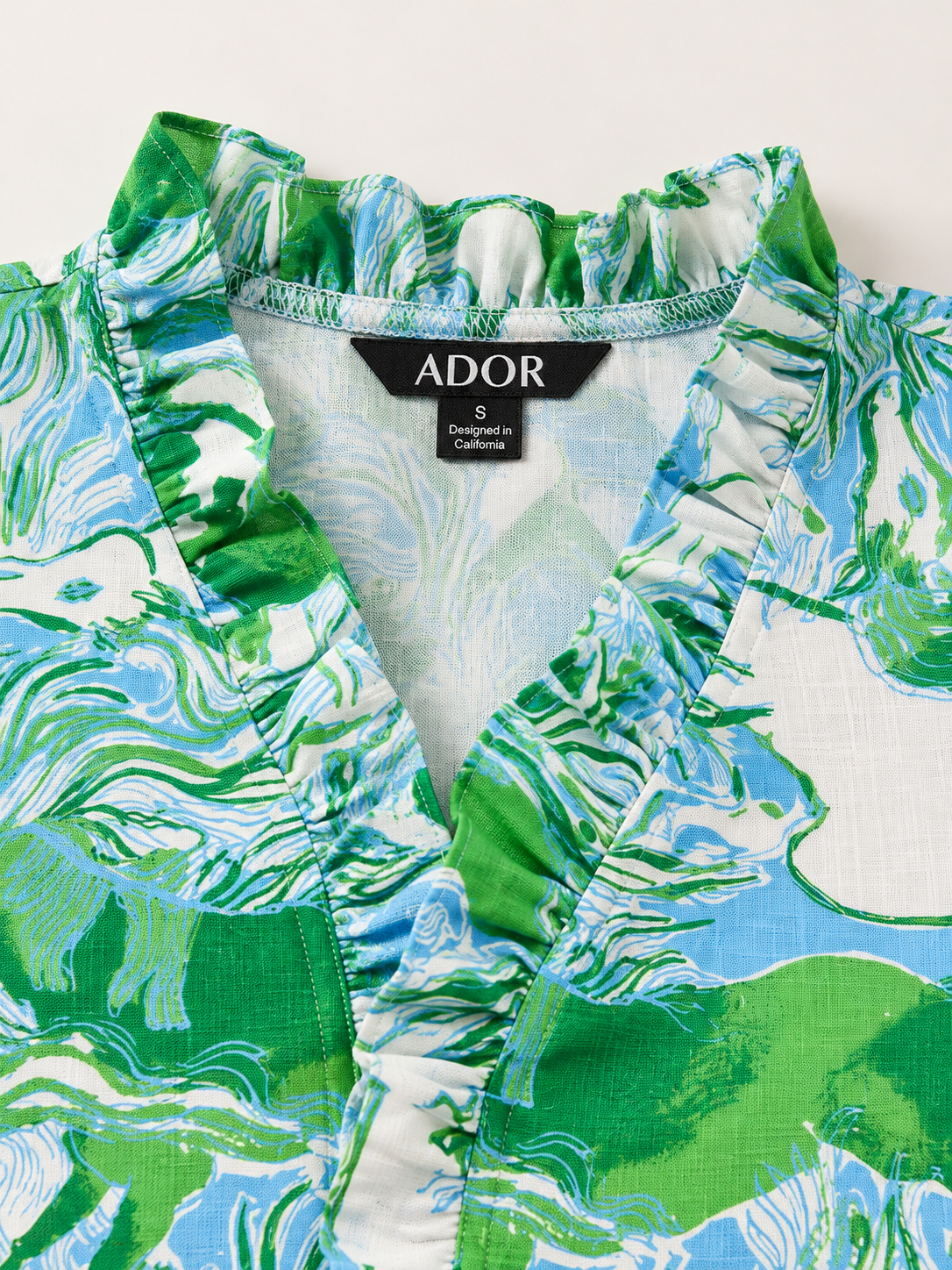 ADOR brand label detail on Graphic Art Mustang Ruffle V-Neck Linen Look Blouse