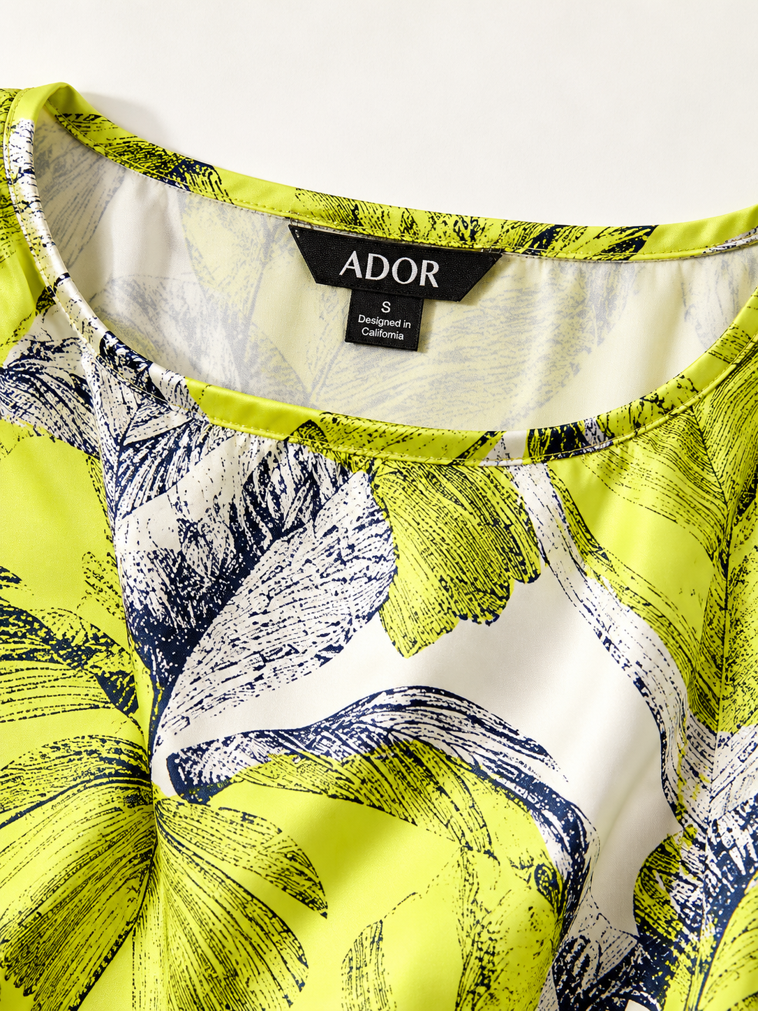 ADOR brand label detail on Citrus Palm Luxe Silky Satin Batwing Top