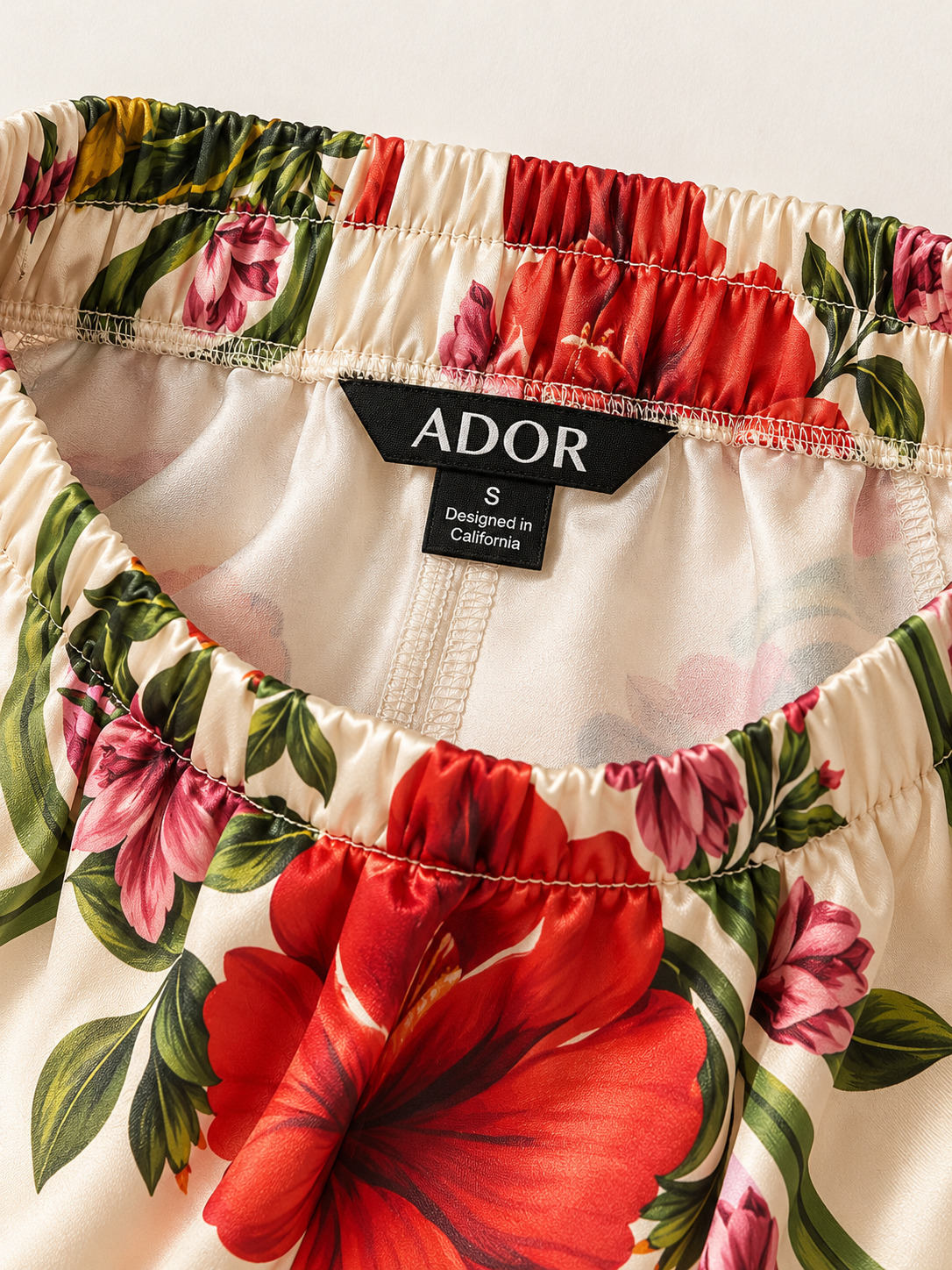 ADOR brand label detail on Hawaii Palm Silky Satin Wide Leg Pants