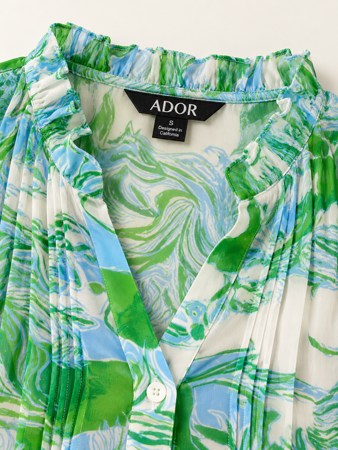 ADOR brand label detail on Graphic Art Mustang Ruffle V-Neck Chiffon Blouse