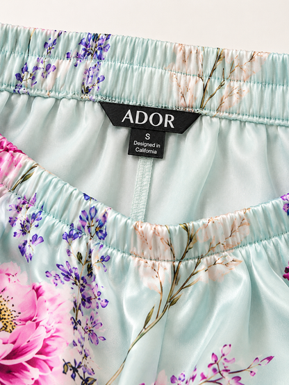 ADOR brand label detail on Pastel Garden Silky Satin Wide Leg Pants