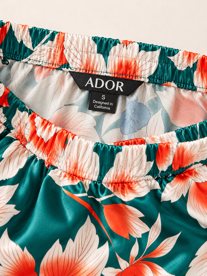 ADOR brand label detail on Deep Green Hibiscus Silky Satin Wide Leg Pants