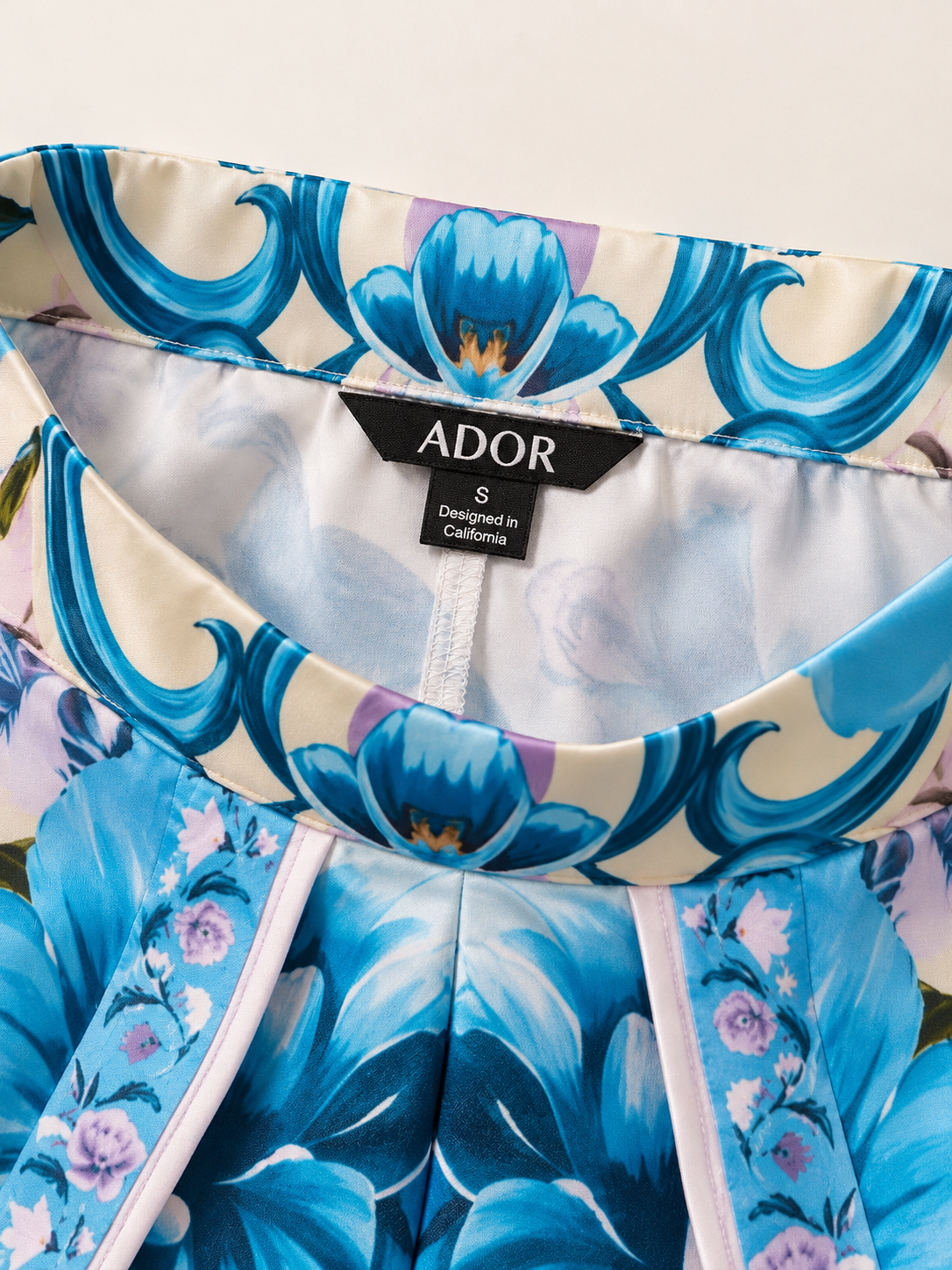 ADOR brand label detail on Hawaii Palm Satin Slit Wide Leg Pants