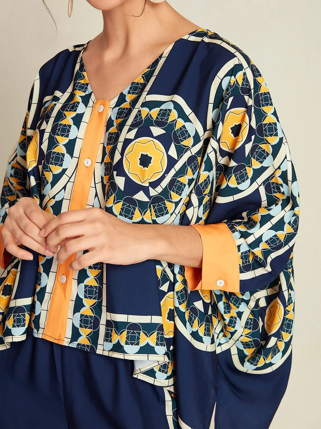 Blusa informal de manga larga con cuello en V, dobladillo irregular y estampado folclórico en color azul marino